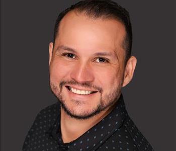 Male employee with brown hair smiling