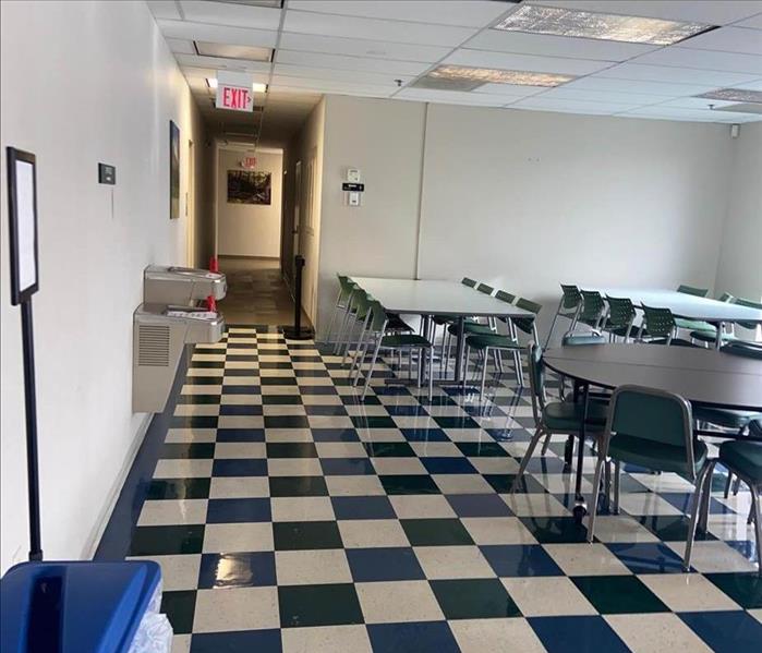 school cafeteria with tables and black white tile floor